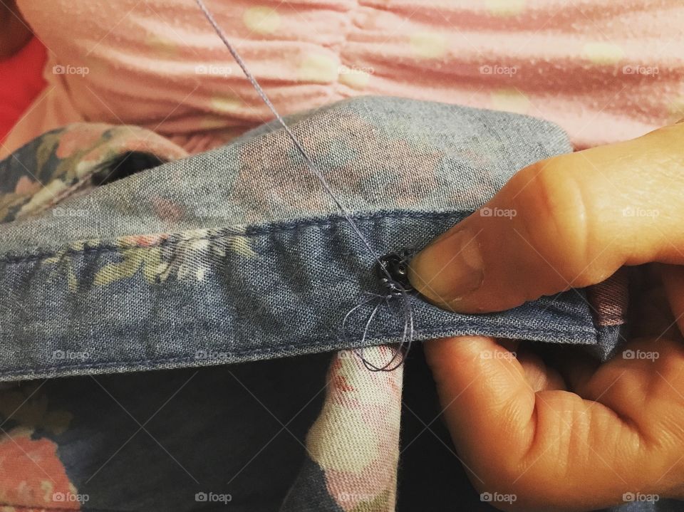 Sewing up snaps on clothing to fix for cooler weather 