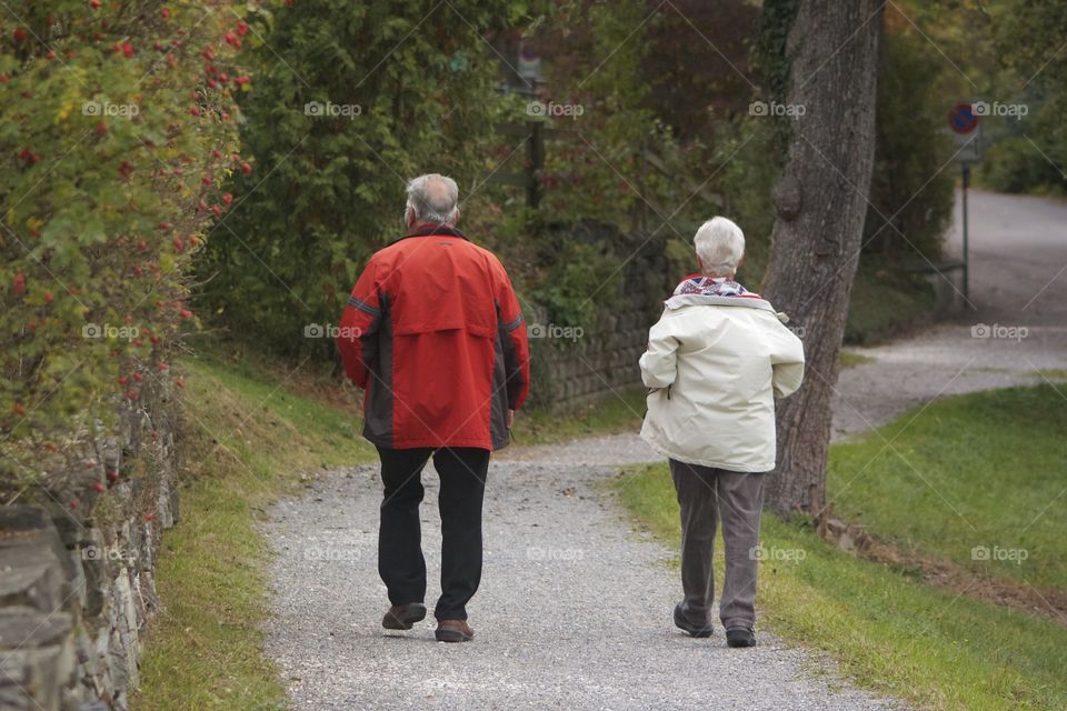 Elderly couples walking on road