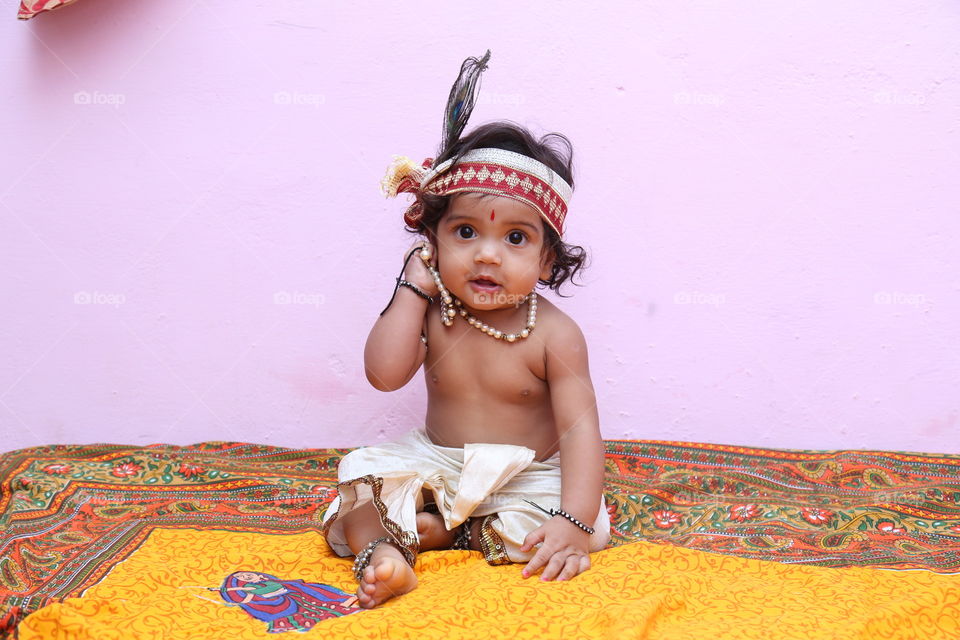 cute baby. photo of baby while makeover as lord krishna