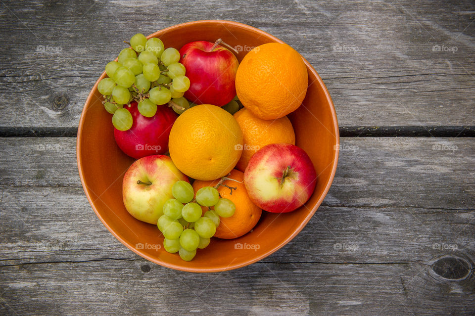 Bowl with fruits on a wooden table
