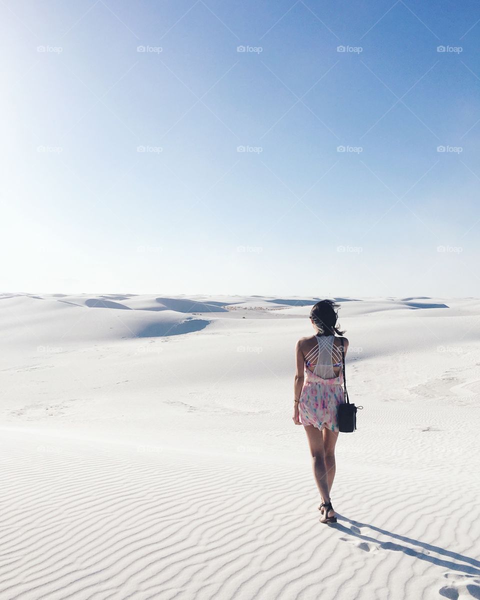 Rare view of girl walking on white sand desert, Mexico