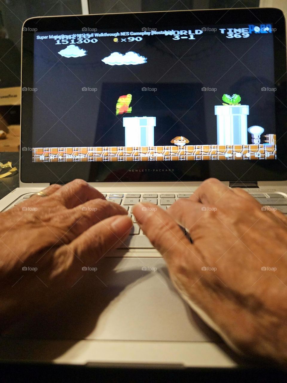 Playing Super Mario Bros on laptop