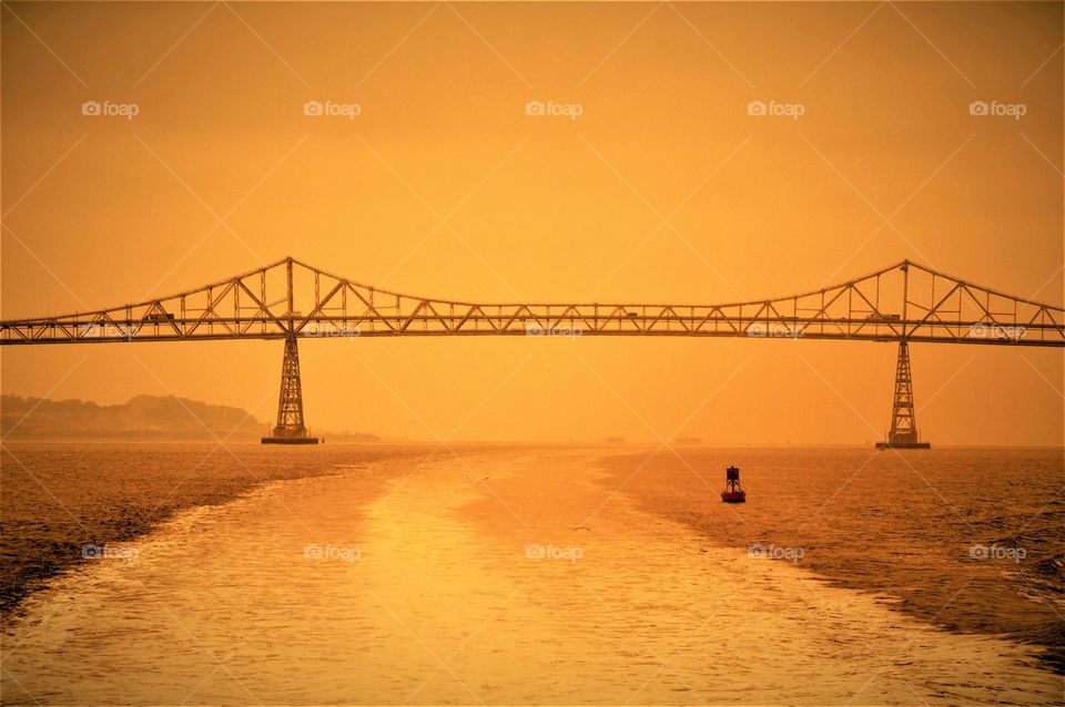 iron bridge stretching across the water from land to land