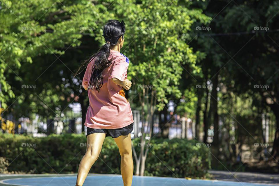 Back view of Asian women was running in the park.