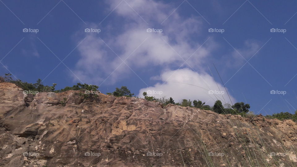 A beautiful scene of hills with cloudy sky.
