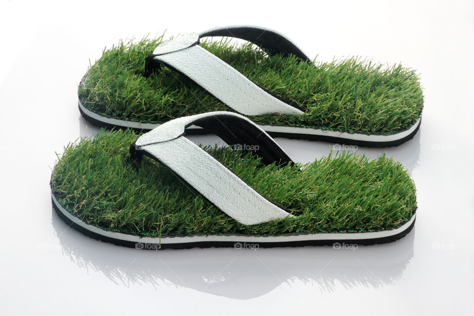 Green grass slipper. Nature's walk concept