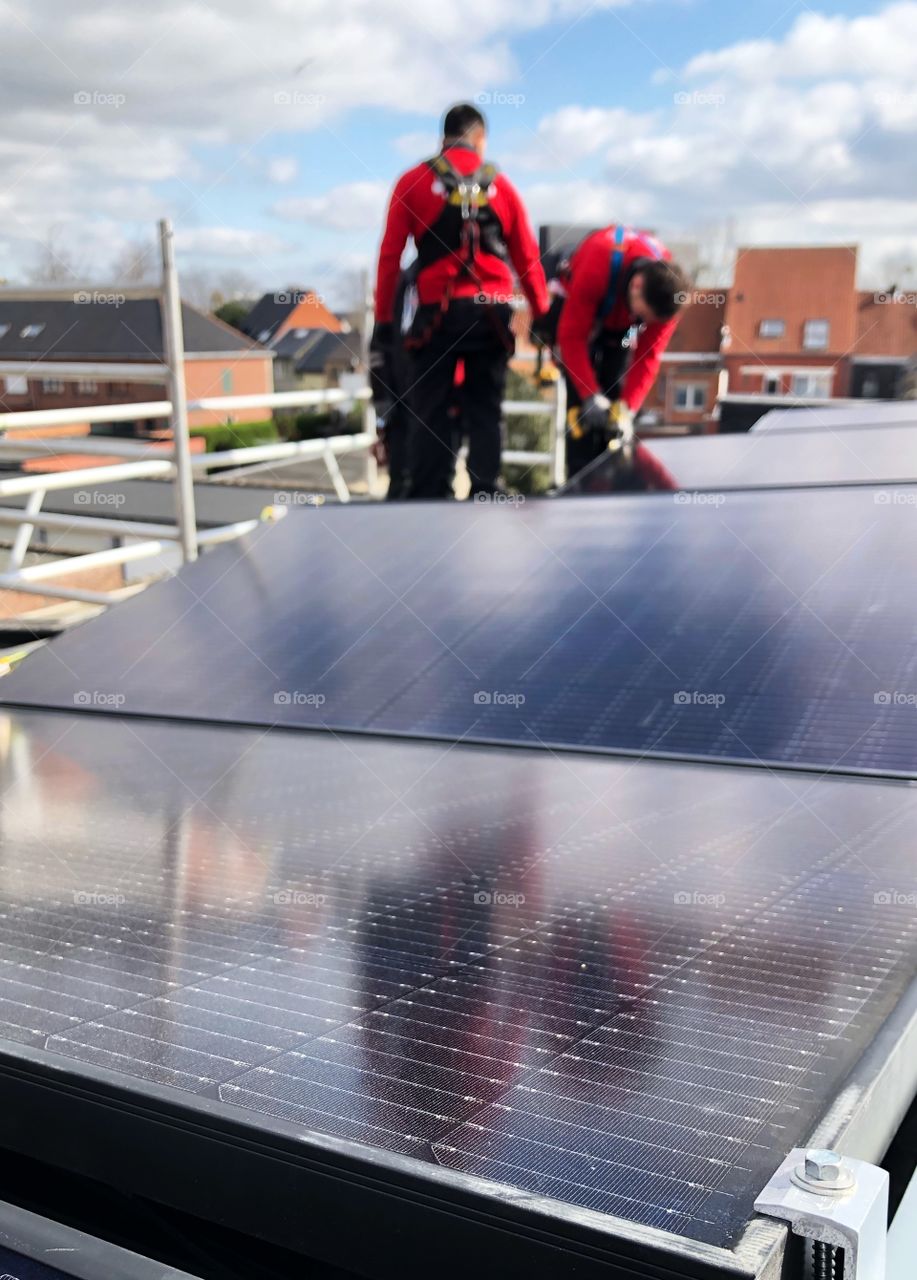 Installing solar panels on a rooftop 