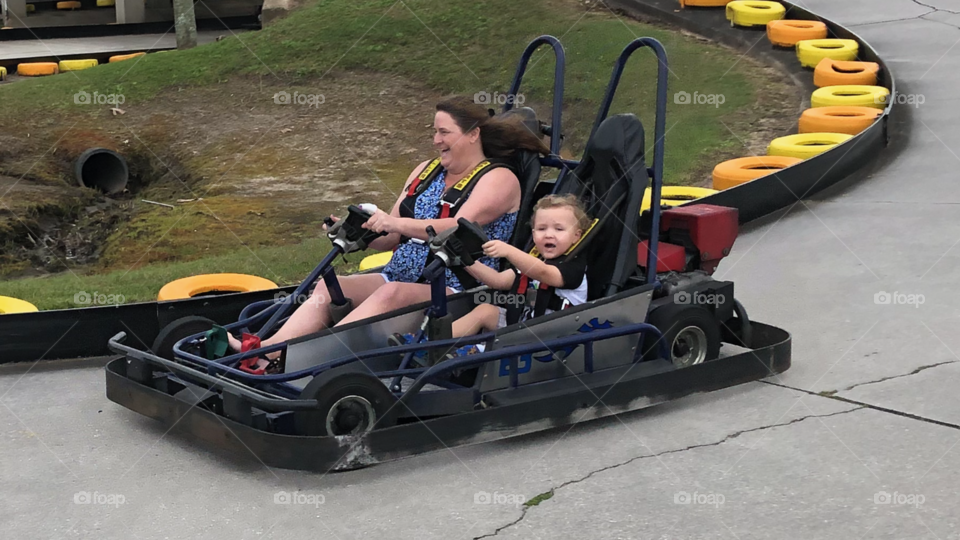 Riding in go kart having family fun outside 