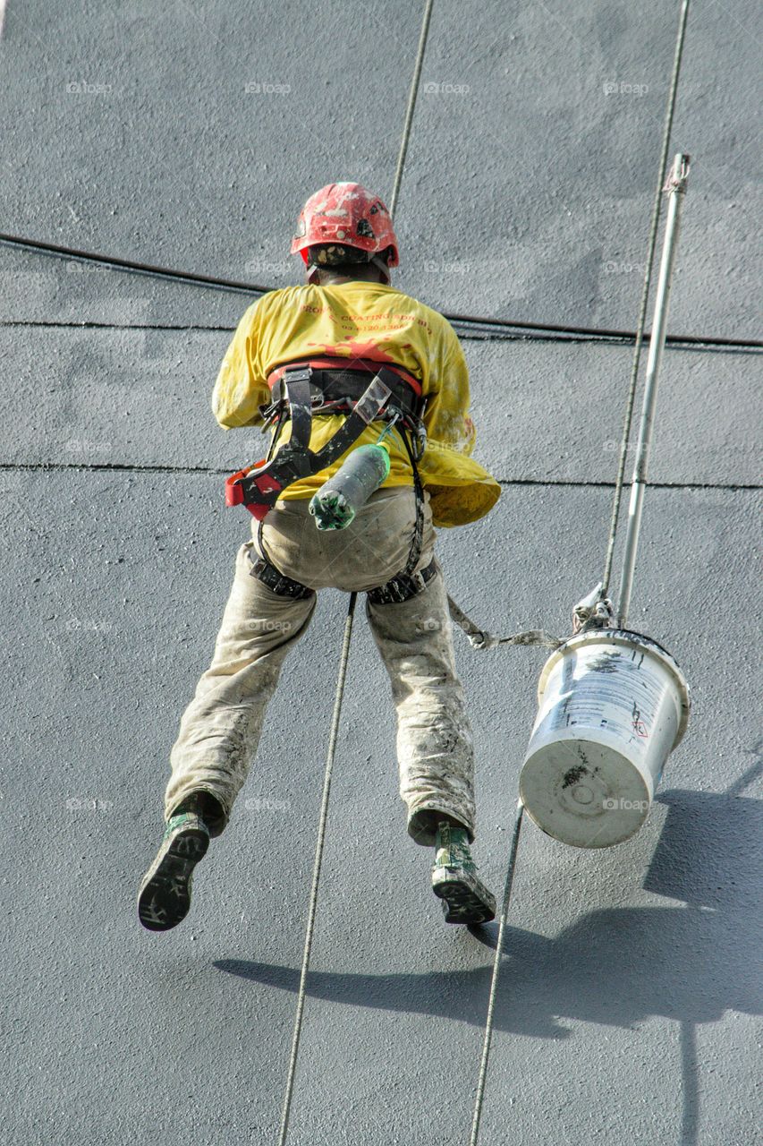 worker abseiling down side of building in Kuala Lumpur Malaysia