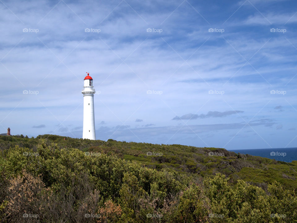 lighthouse in front of blue sky