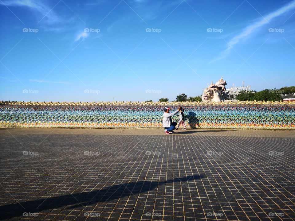 Father and child on holiday with sunny day.