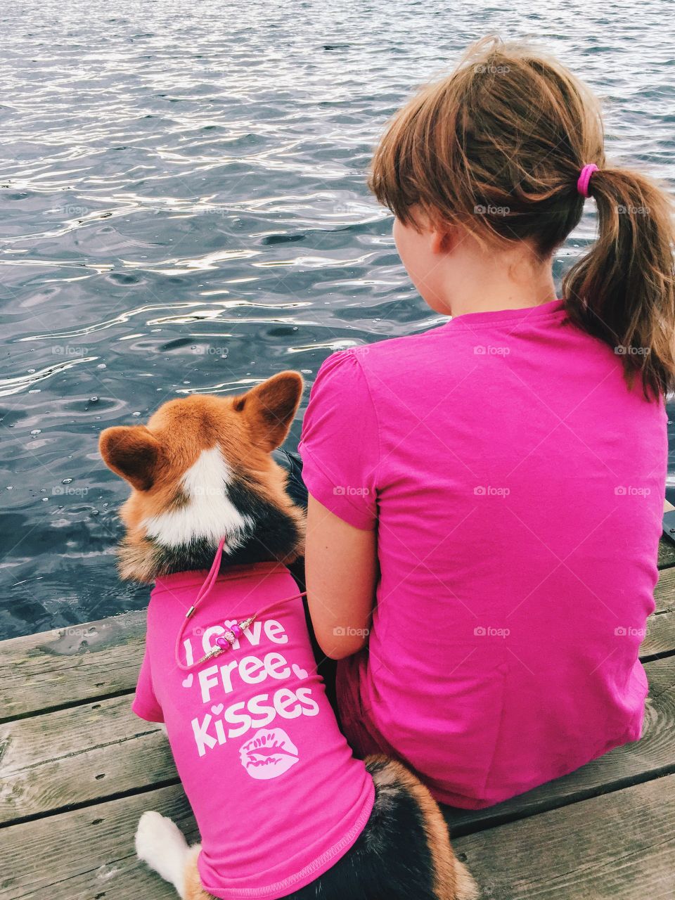 Girl and her dog dressed in pink