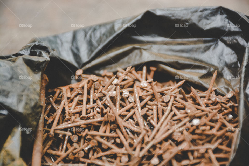 a pile of rusty nails in a plastic bag