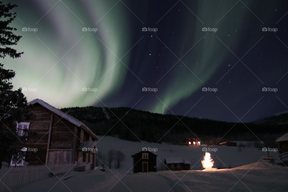 Old houses in winter an northern light
