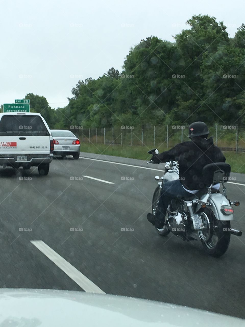Biker on custom Harley riding in the rain 💦