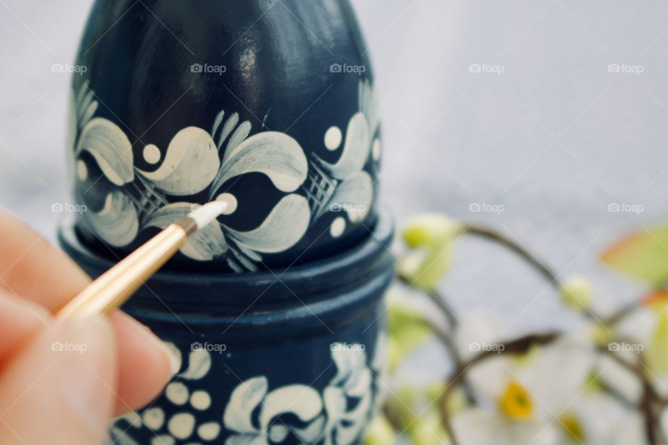 Painting a wooden egg