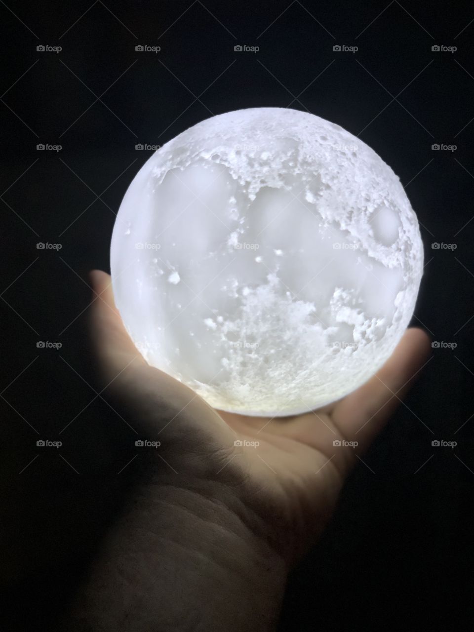 Hand holding the moon