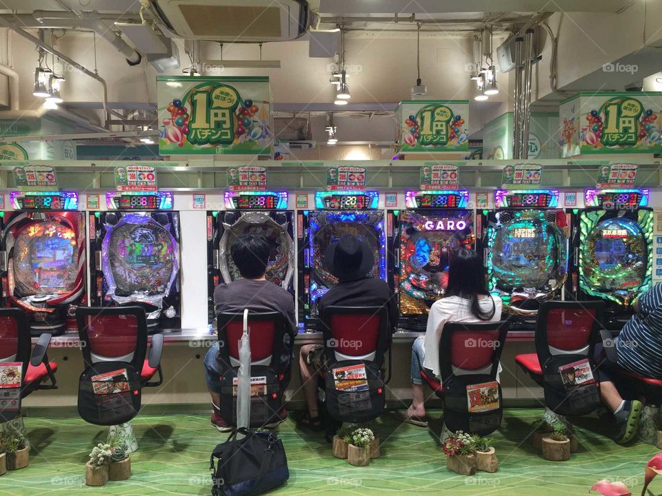Japanease people playing pachinko in tokyo. Pachinko is a game that is an only legal form of gambling