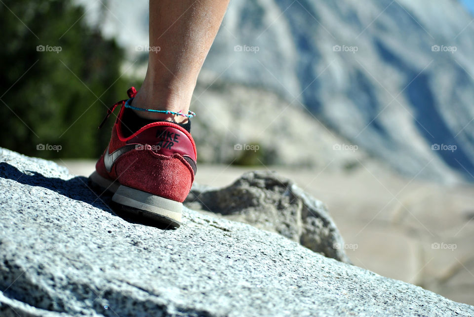 red nike Sneakers, shoes close-up against a hiking view