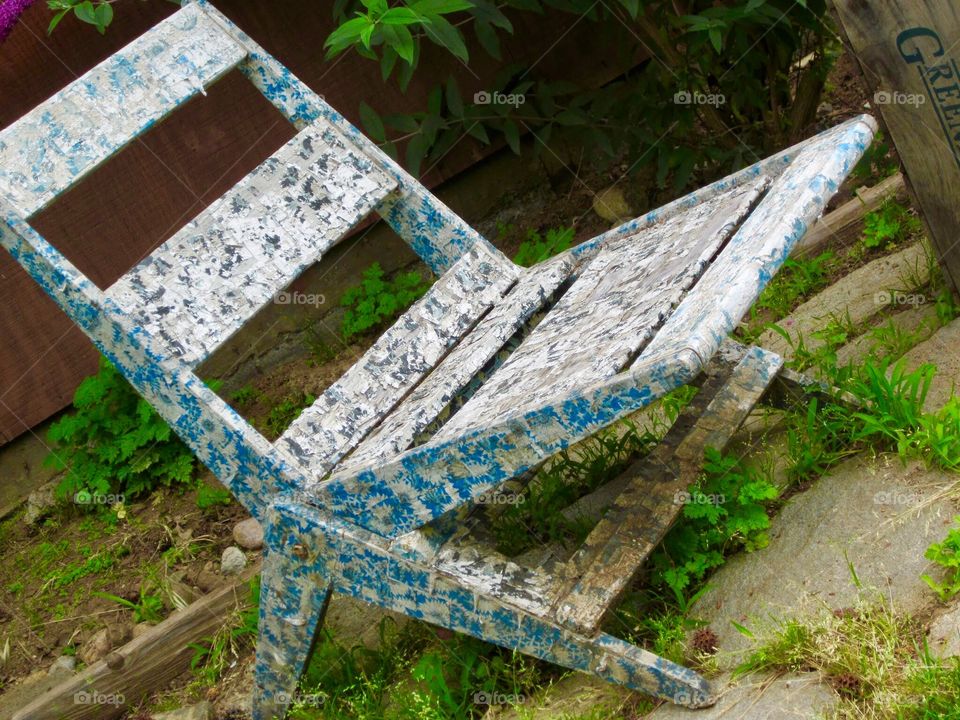 White and blue paint speckled folding chair