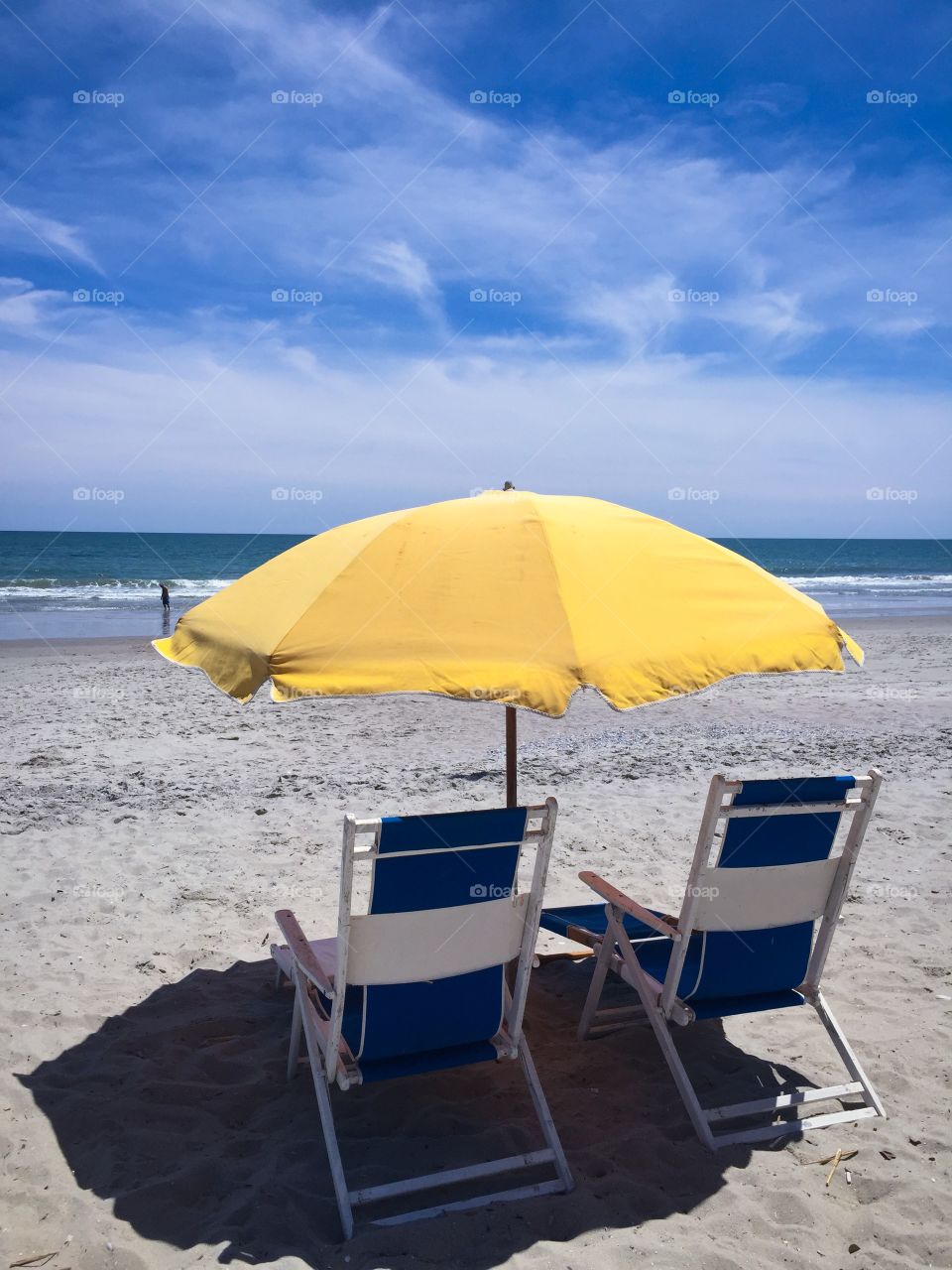 Beach. Pretty beach scene with two chairs and a yellow umbrella