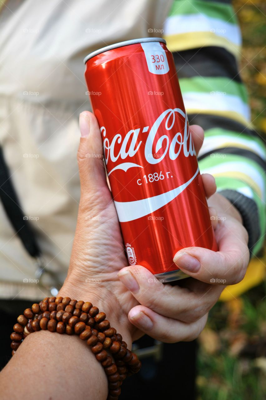 coca cola in the hands women, picnic outdoor