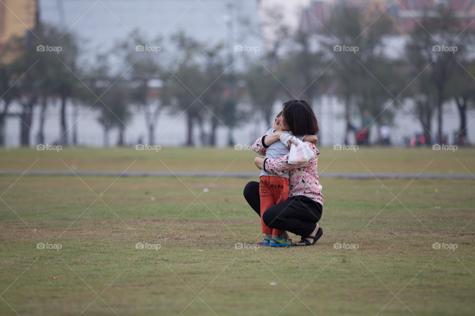 Woman holding her child in the park 