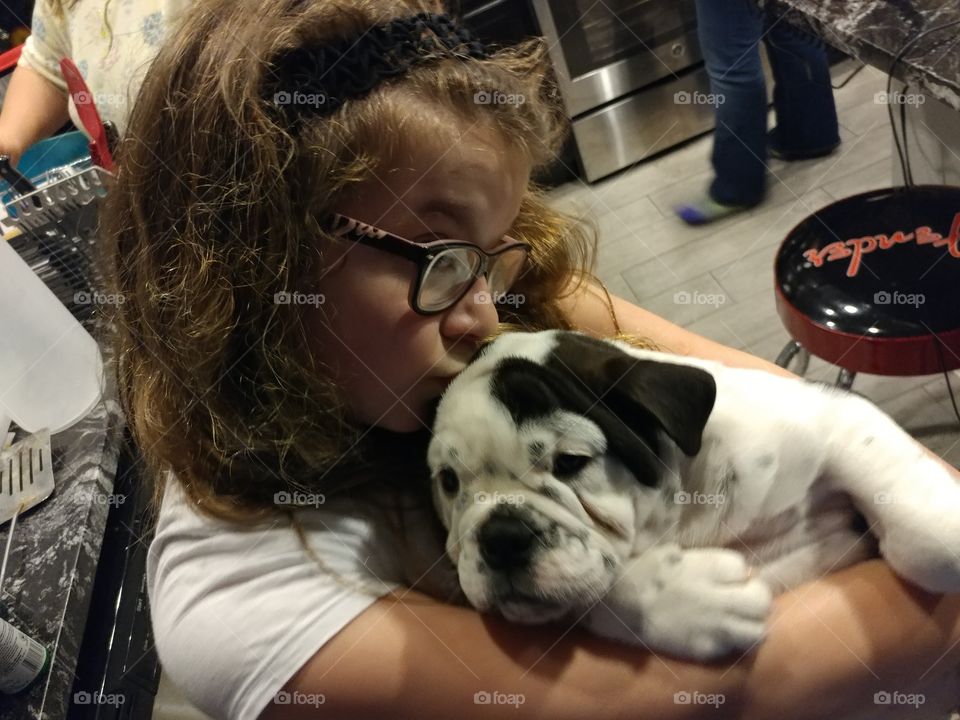Little girl and English Bulldog puppy