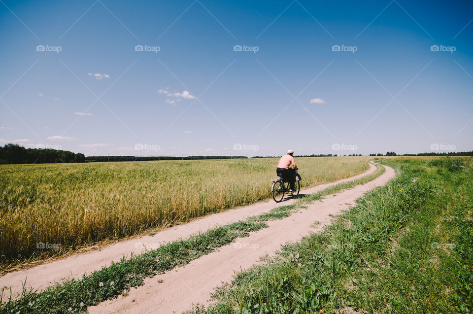 Man on bycicle in field