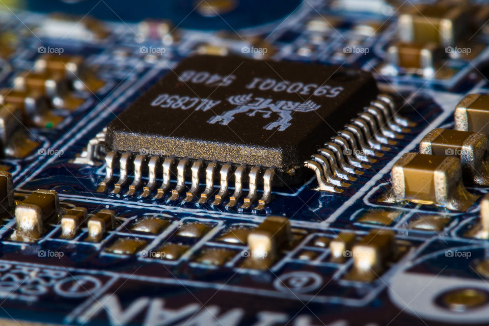 Macro image showing small details on a motherboard of a computer. Image of electronics close up.