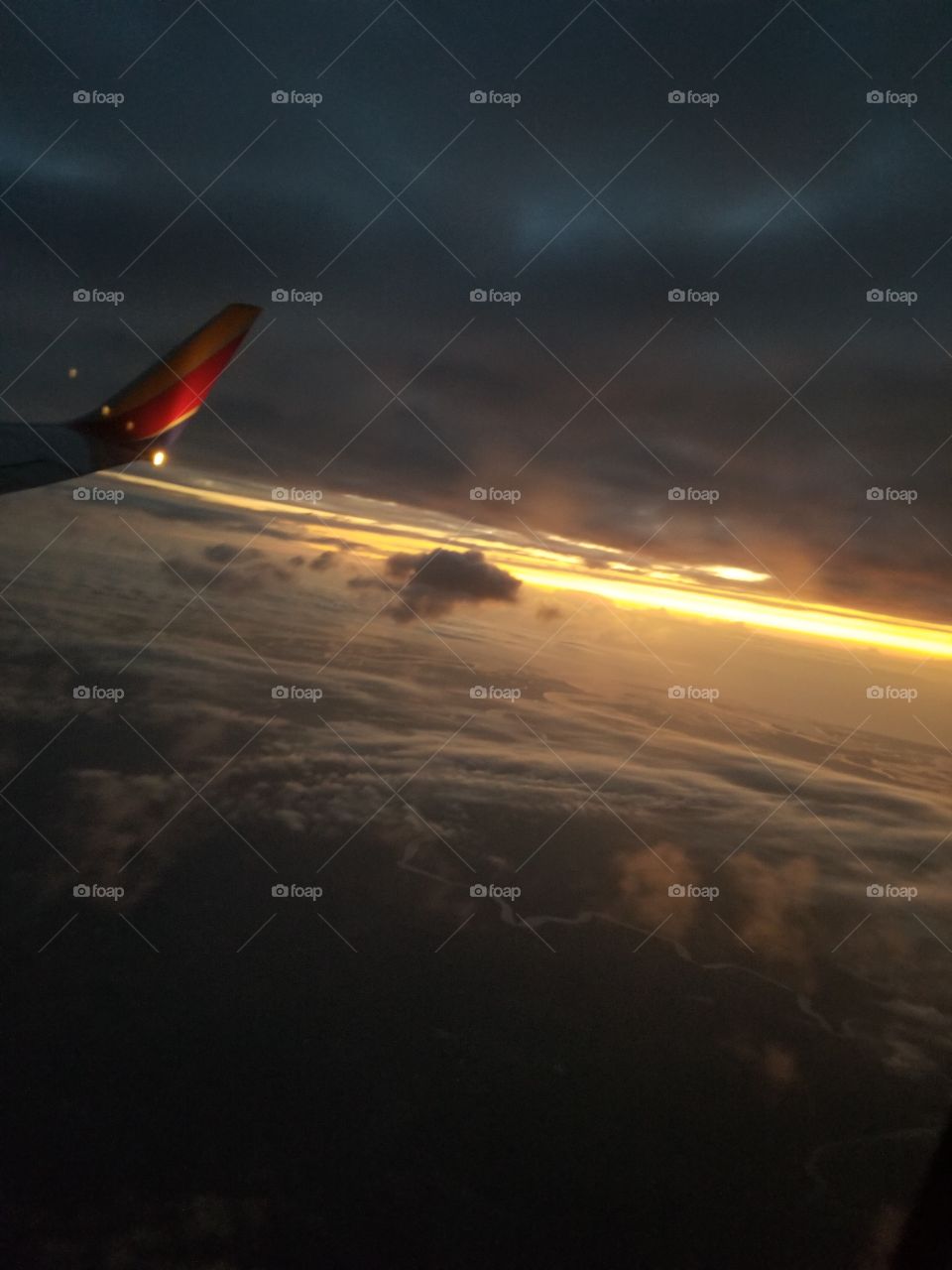 cloudy sunrise on flight