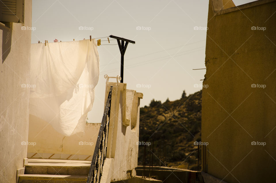 a pristine white blanket drying on a line