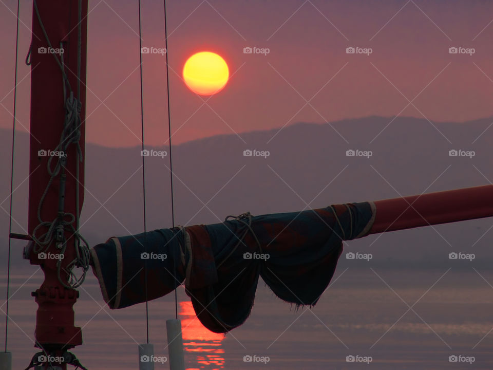 Close-up of sail wrapped on mast