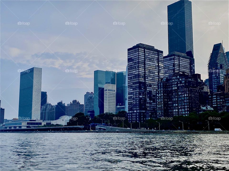 The “Upper East Side” of “Manhattan” can be seen from the water of the “East River” as we are making our way towards our home port which is “Newtown Creek” from “Mamaroneck” on our new “23 O’Day” sailboat. 2023. Hypnotic Productions