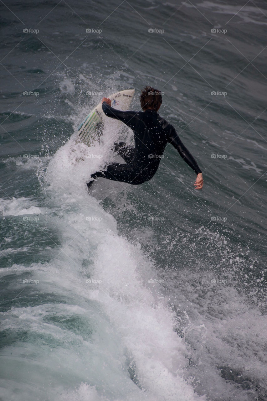 Surfer riding the curl on the California coast