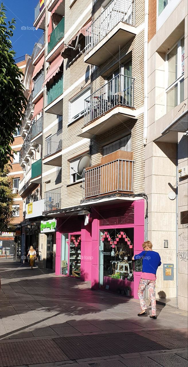 walk through the streets of Madrid admiring the structures of the buildings and their striking colors that highlight the establishments