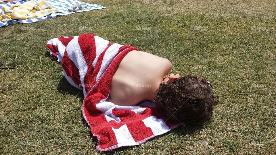 summer beach sleeping. son sleeping poolside