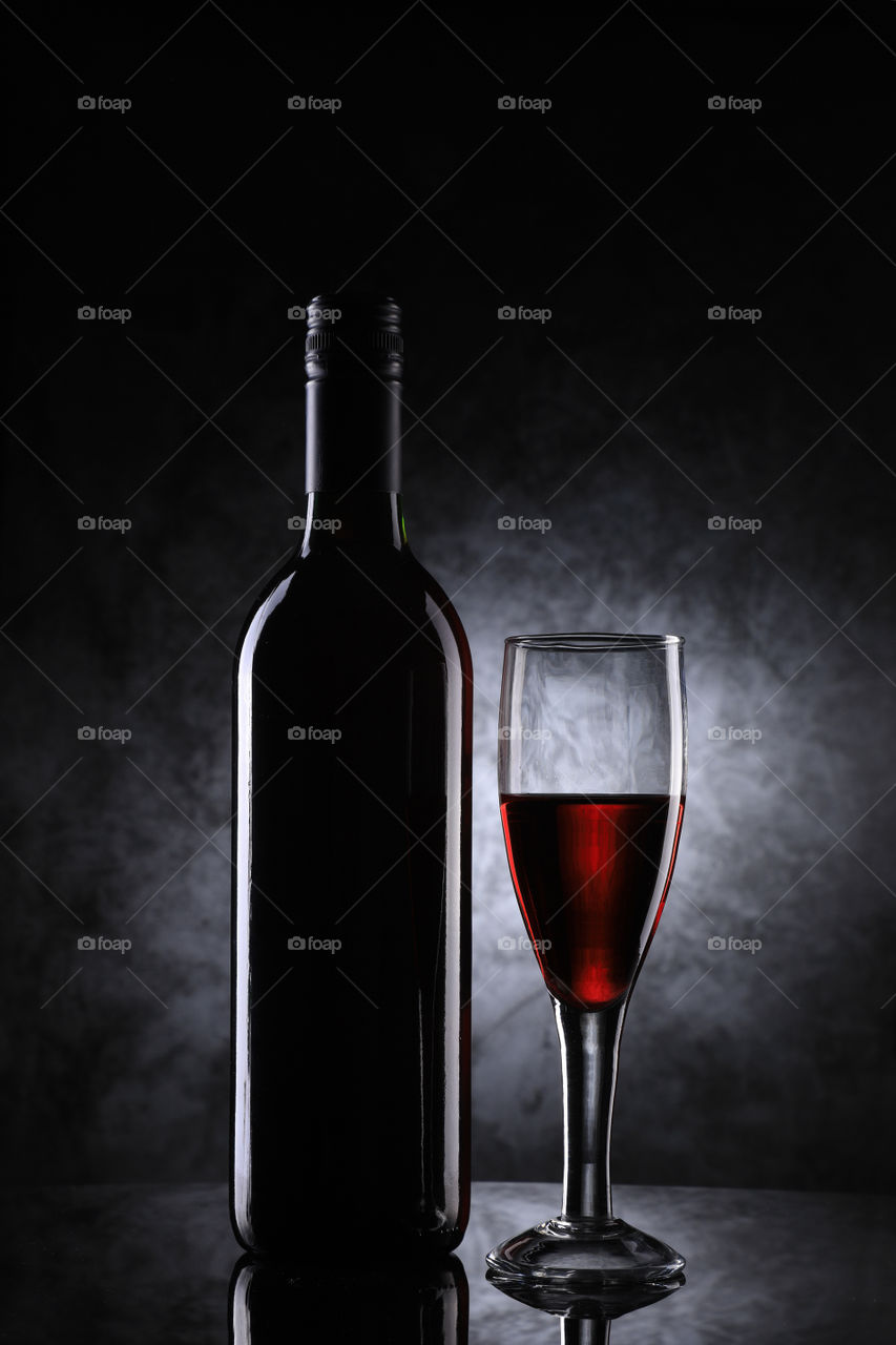 Red wine glass and bottle