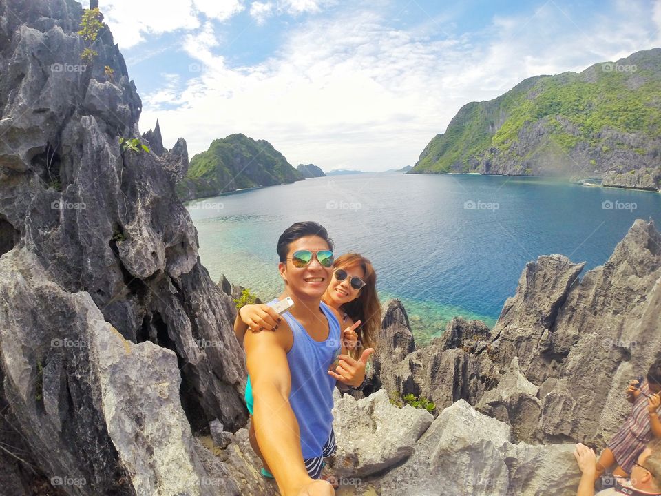 Cute couple taking selfie in rocky mountain