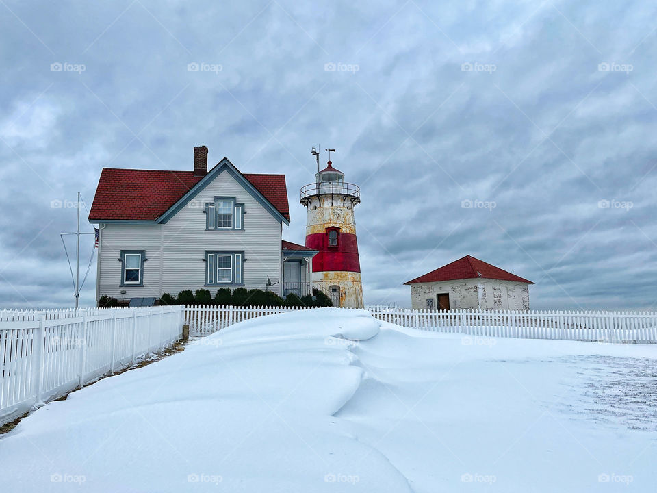 Lighthouse in New England after it snowed 