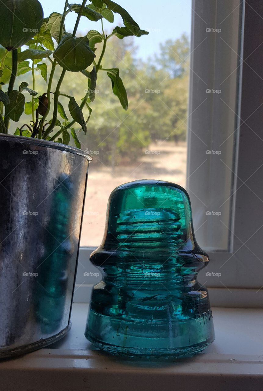 Green Glass electric insulator on my kitchen window sill