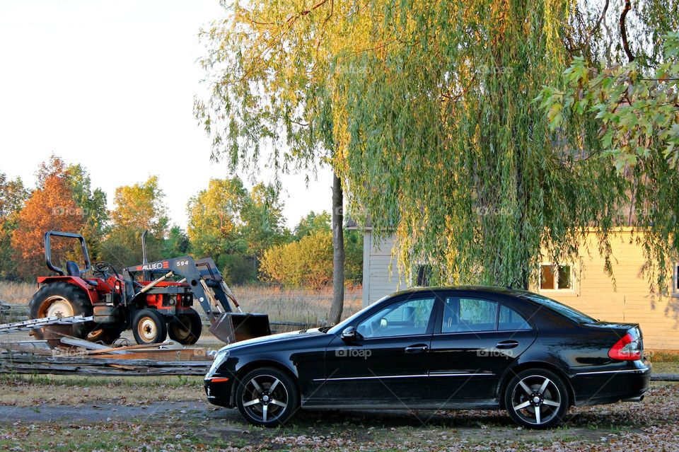 Town and country Mercedes Benz and tractor