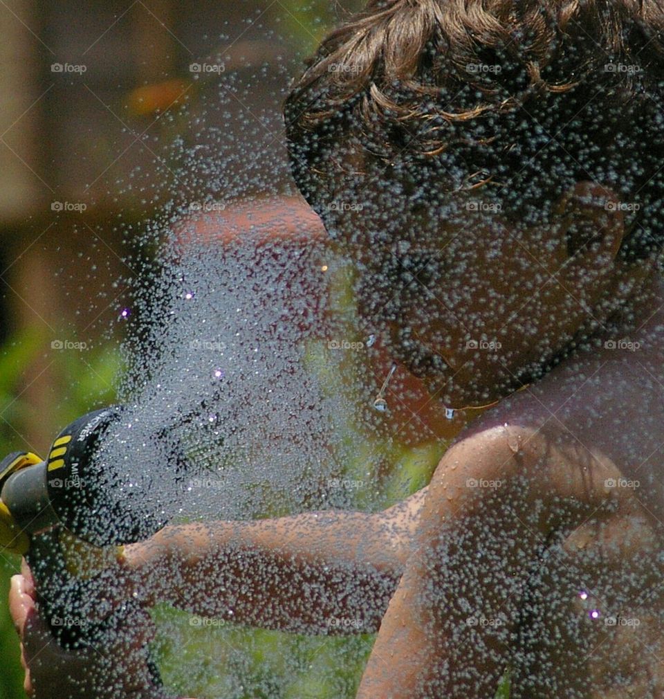 boy hoses himself in the face