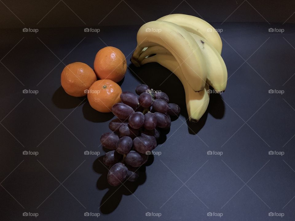 Orange, banana and grapes
