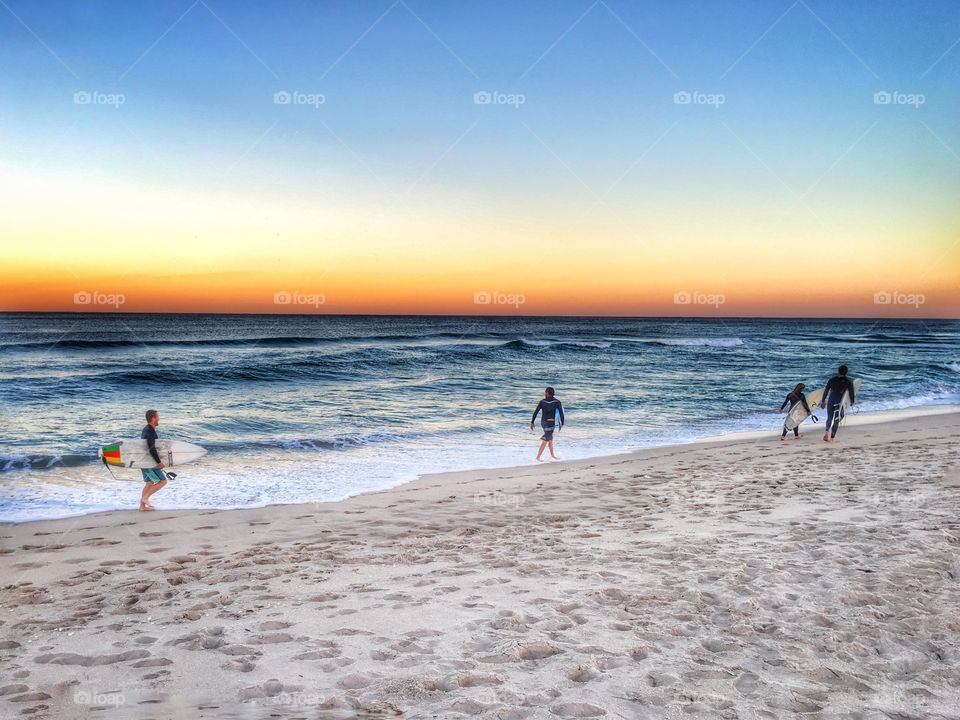 Surfers walking on the beach 