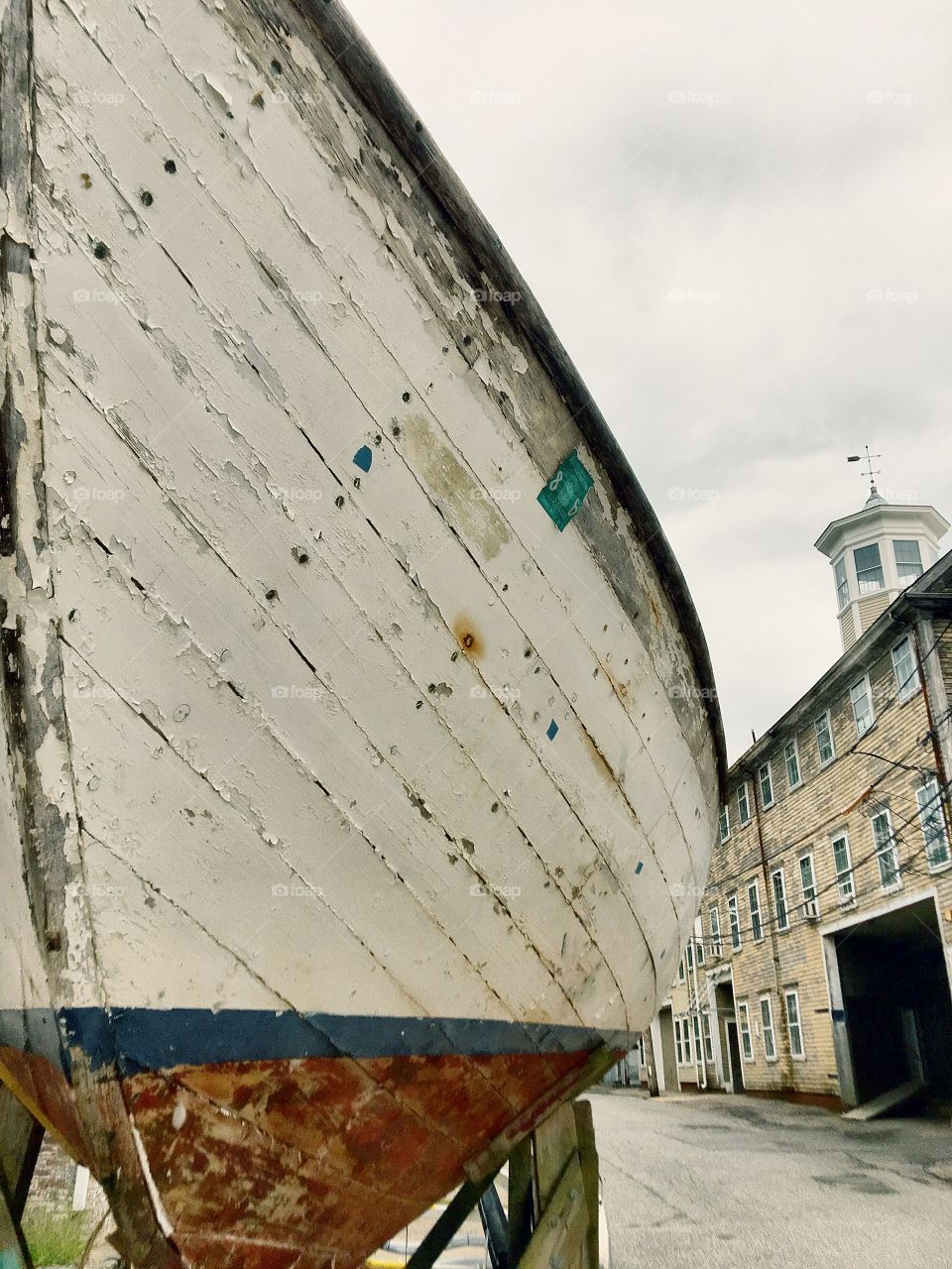An old boat outside of an old downtown building