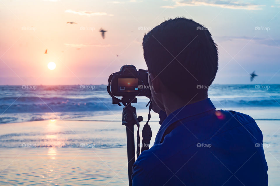 Photographer, sunset and ocean