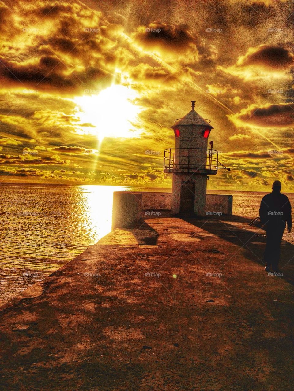 Man walking along the pier