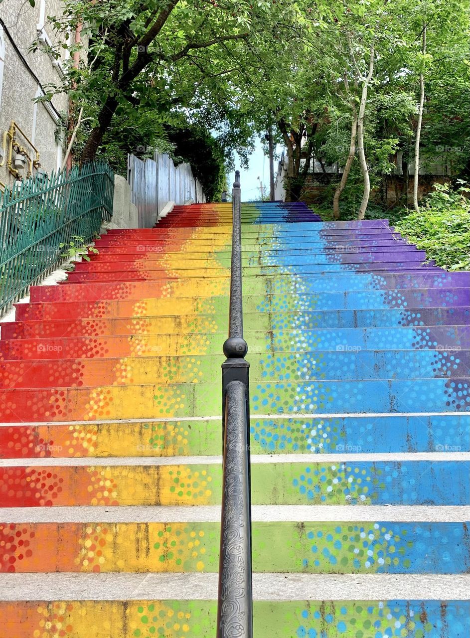 Rainbow colored stairs going up in the city - LGBTQIA colors flag