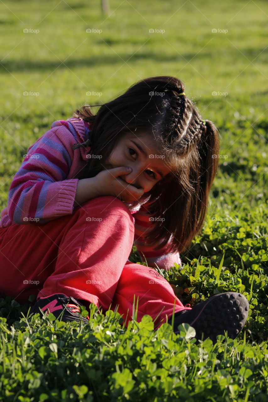 Girl sitting on grass and smiling